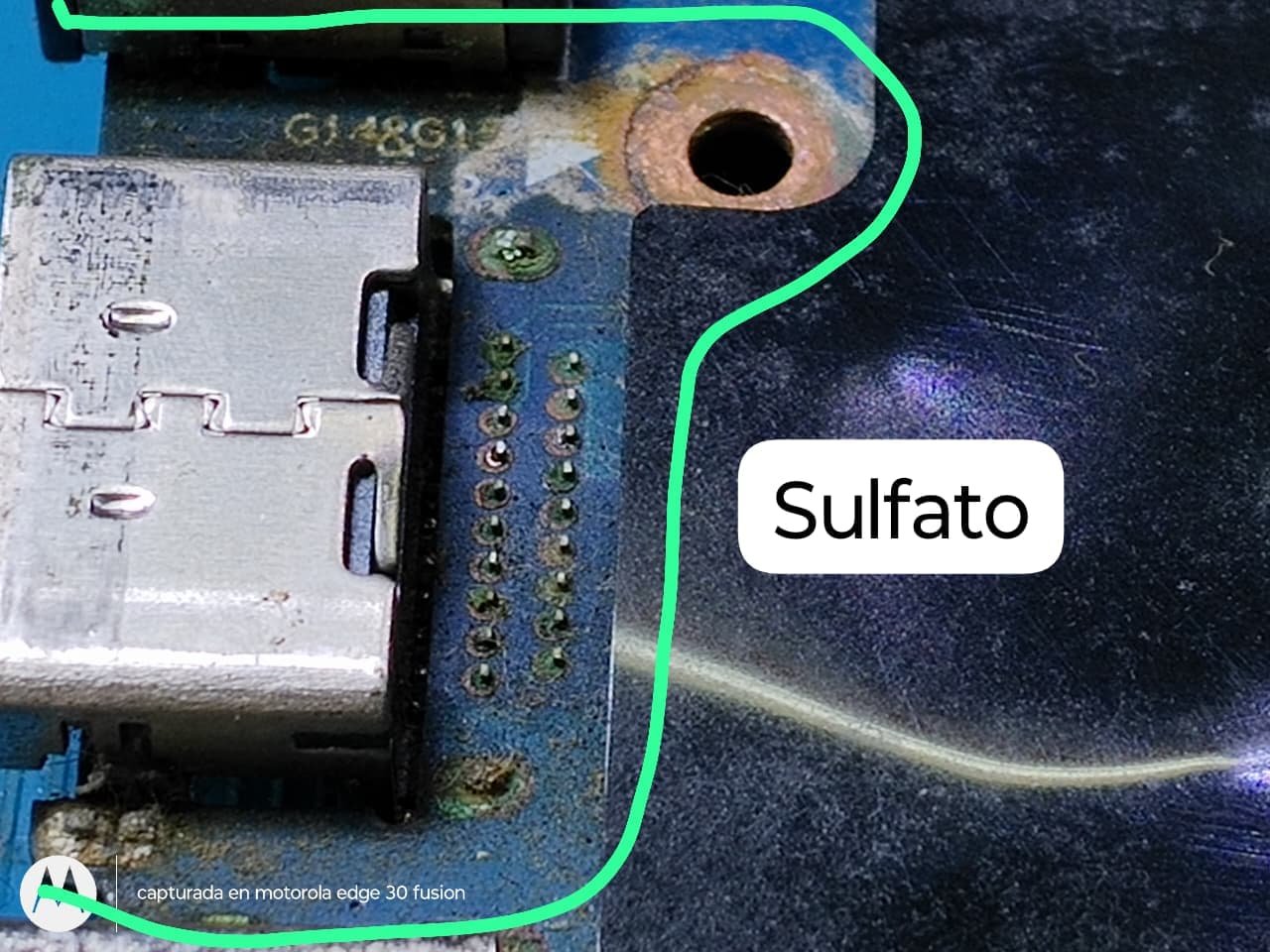 Sulfato en la placa de una notebook, cerca de los puertos de carga